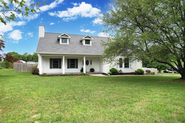 view of front of house with a chimney, a front lawn, fence, a porch, and roof with shingles