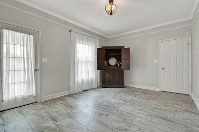 entrance foyer featuring baseboards and crown molding