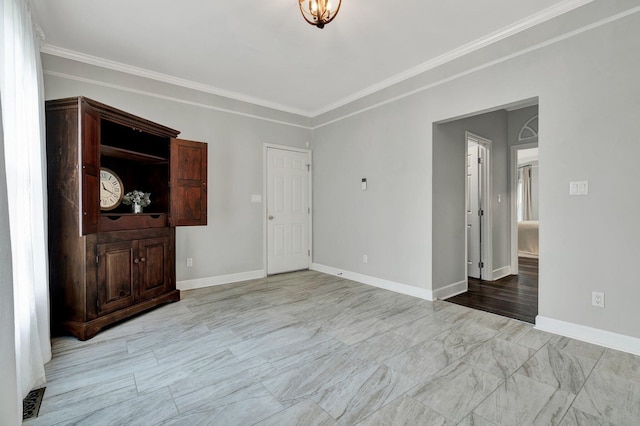 unfurnished living room featuring baseboards and crown molding