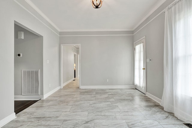 spare room with baseboards, visible vents, marble finish floor, and crown molding