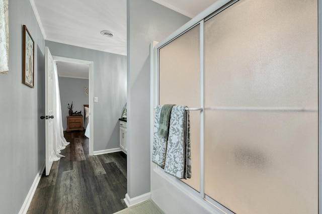 bathroom with wood finished floors, visible vents, ensuite bath, crown molding, and baseboards