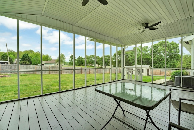 unfurnished sunroom with a ceiling fan