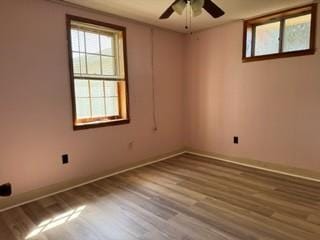 spare room with ceiling fan, baseboards, and wood finished floors