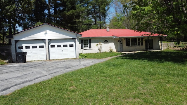 ranch-style house with a front lawn, driveway, metal roof, a garage, and brick siding