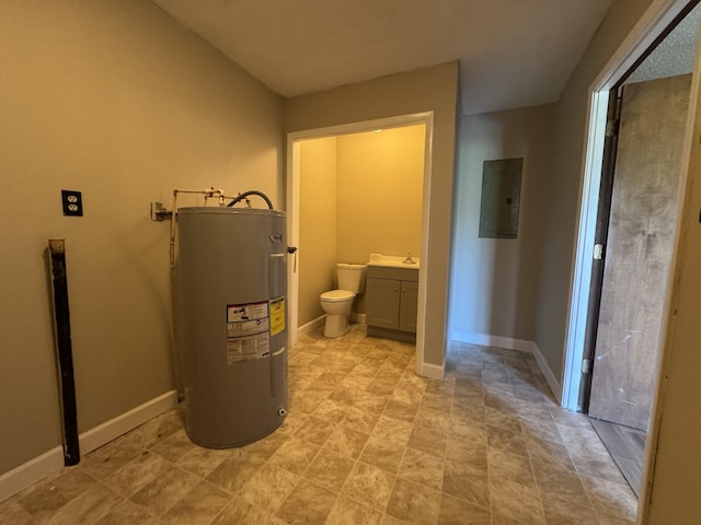 bathroom featuring electric panel, toilet, baseboards, water heater, and vanity