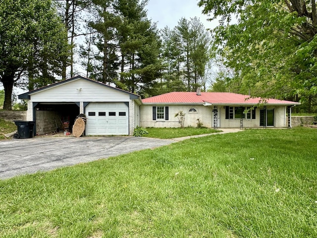 ranch-style home with brick siding, a garage, a front yard, and metal roof