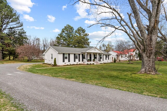 8803 Horton Hwy, College Grove, TN 37046 - view of front facade with stucco siding, a front lawn, gravel driveway, and covered porch
