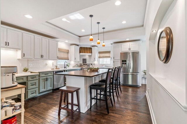 8803 Horton Hwy, College Grove, TN 37046 - kitchen with decorative backsplash, a breakfast bar, dark wood-style floors, and appliances with stainless steel finishes