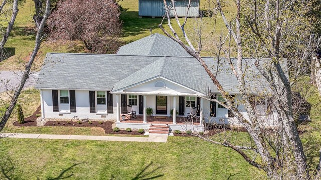 8803 Horton Hwy, College Grove, TN 37046 - view of front of home with a storage shed, a shingled roof, a porch, an outbuilding, and a front yard