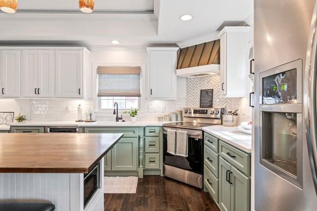 8803 Horton Hwy, College Grove, TN 37046 - kitchen featuring green cabinets, butcher block counters, stainless steel appliances, dark wood finished floors, and ornamental molding