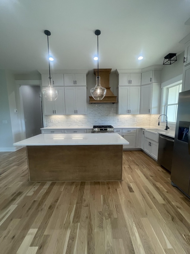 1167 Rock Church Rd, Dickson, TN 37055 - kitchen with a center island, custom exhaust hood, a sink, light countertops, and appliances with stainless steel finishes