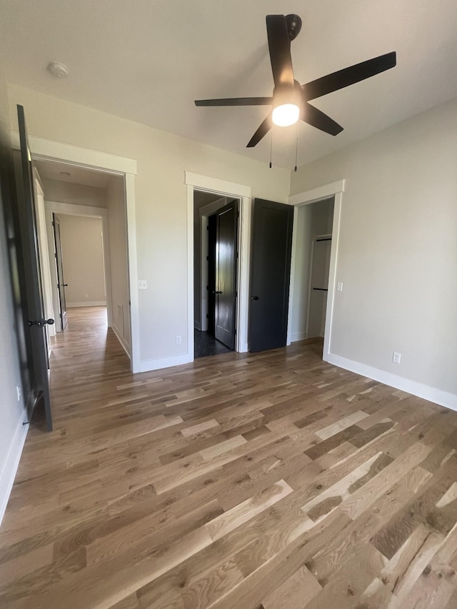 1167 Rock Church Rd, Dickson, TN 37055 - unfurnished bedroom featuring wood finished floors, baseboards, and ceiling fan