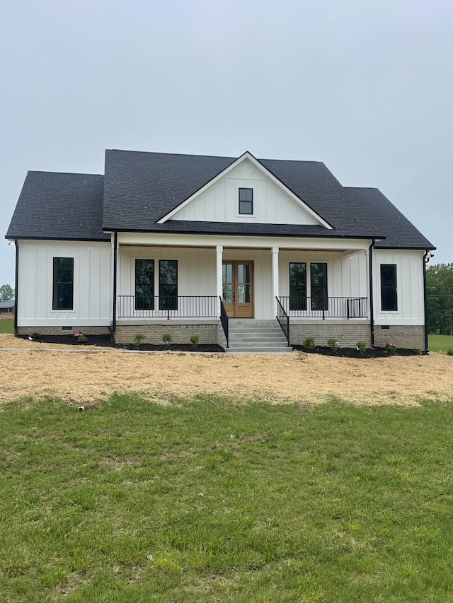 1167 Rock Church Rd, Dickson, TN 37055 - modern farmhouse featuring covered porch, board and batten siding, a shingled roof, and a front lawn
