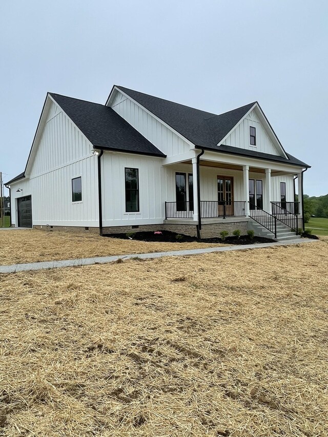 1167 Rock Church Rd, Dickson, TN 37055 - modern inspired farmhouse featuring a shingled roof, board and batten siding, covered porch, and crawl space