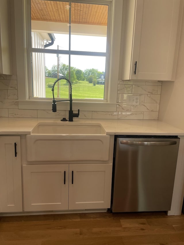 1167 Rock Church Rd, Dickson, TN 37055 - kitchen with backsplash, white cabinetry, stainless steel dishwasher, and a sink
