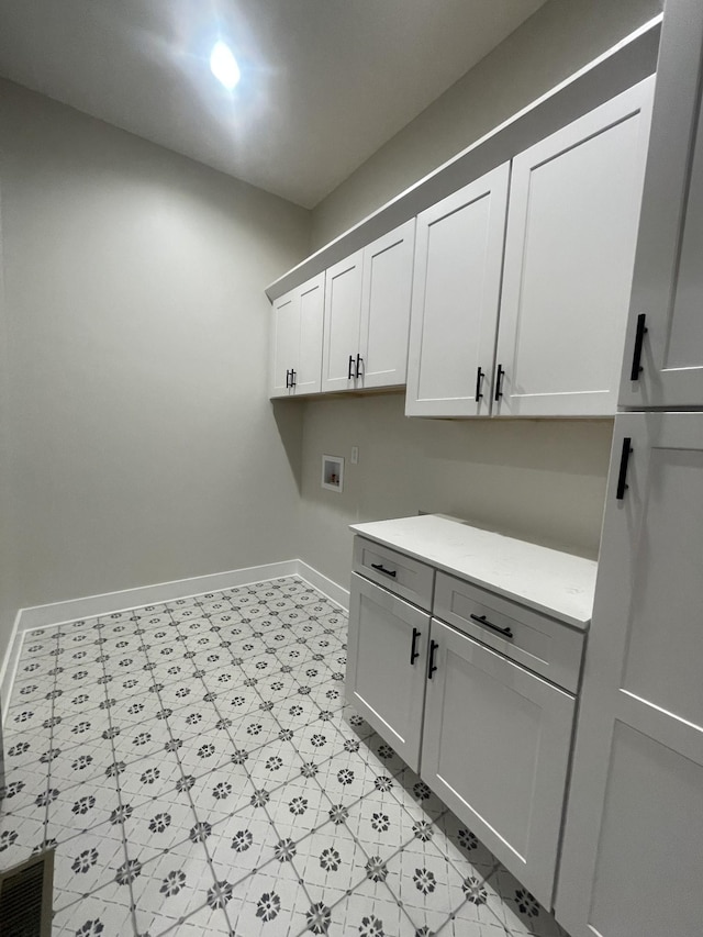 1167 Rock Church Rd, Dickson, TN 37055 - clothes washing area featuring cabinet space, light floors, baseboards, and hookup for a washing machine