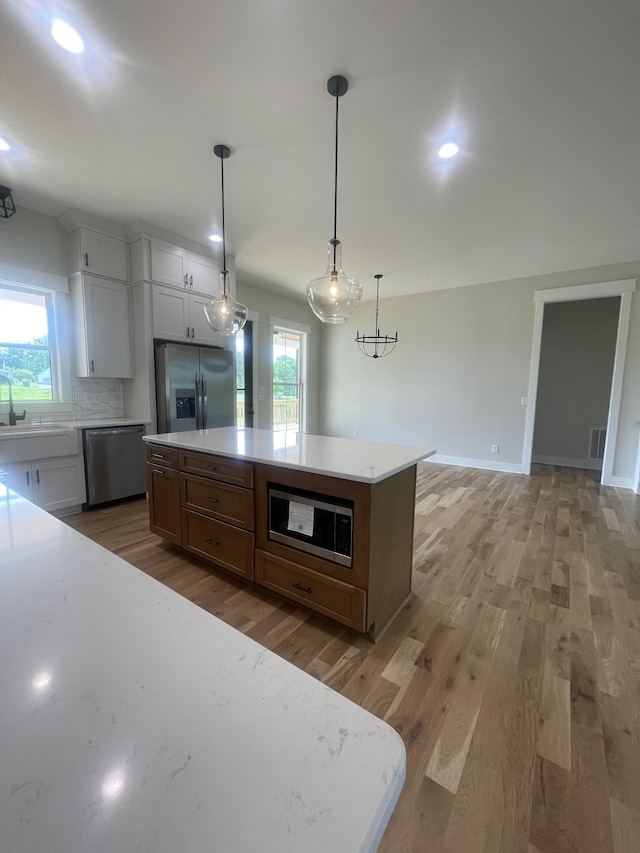 1167 Rock Church Rd, Dickson, TN 37055 - kitchen with light countertops, stainless steel appliances, light wood-style flooring, and recessed lighting