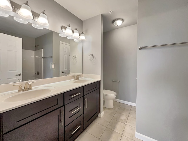 full bathroom with toilet, walk in shower, a sink, and double vanity