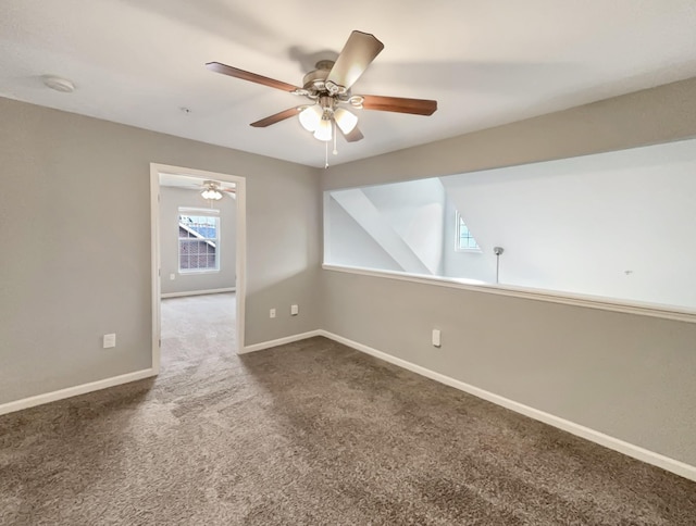 carpeted empty room with ceiling fan and baseboards