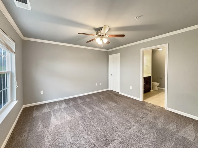 unfurnished bedroom featuring carpet floors, visible vents, crown molding, and baseboards