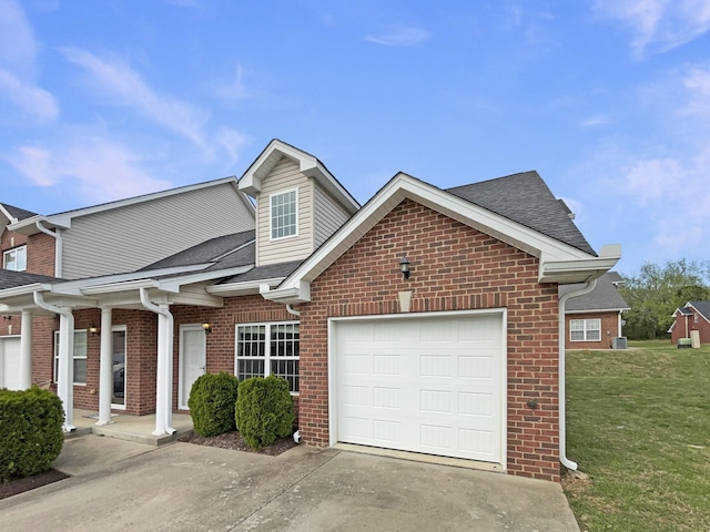 view of front of house with concrete driveway, brick siding, a front yard, and a garage