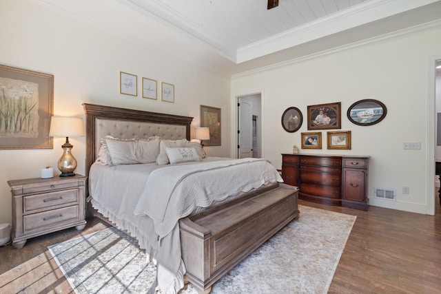 703 Gaither Hinson Rd, Waynesboro, TN 38485 - bedroom with crown molding, dark wood finished floors, baseboards, a tray ceiling, and visible vents