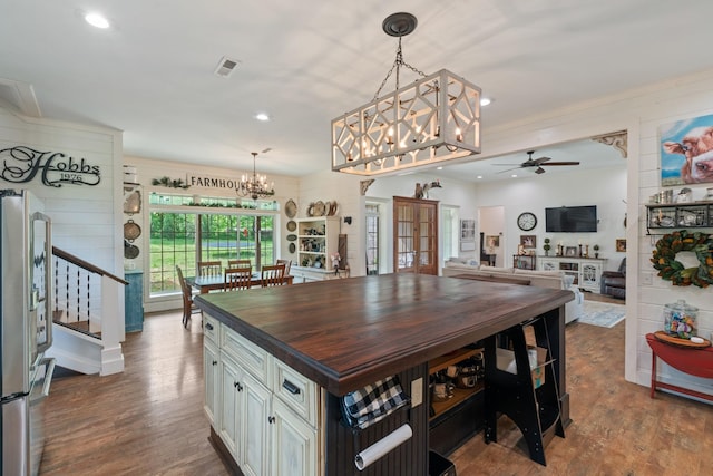 703 Gaither Hinson Rd, Waynesboro, TN 38485 - dining room featuring stairs, visible vents, wood finished floors, and ceiling fan with notable chandelier