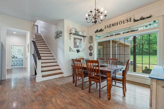 703 Gaither Hinson Rd, Waynesboro, TN 38485 - dining area featuring crown molding, wood walls, wood-type flooring, stairs, and a chandelier