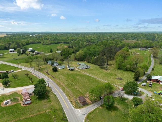 drone / aerial view featuring a wooded view