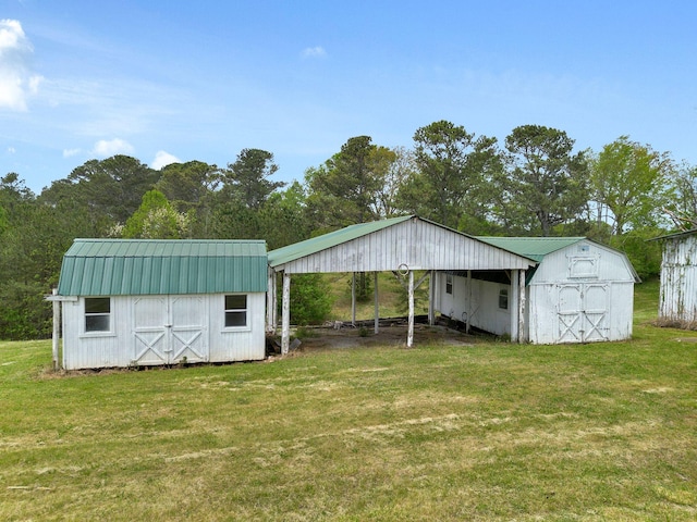 view of outbuilding featuring a carport and an outdoor structure