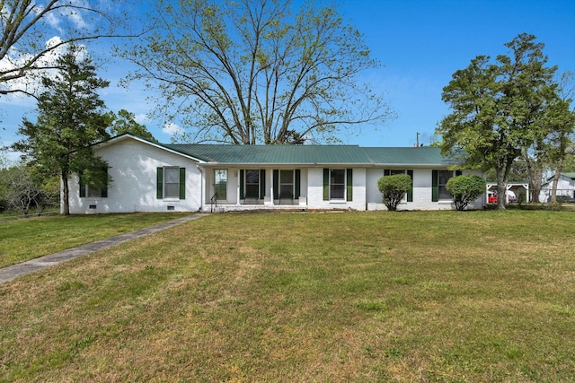 ranch-style house with brick siding, a front yard, and metal roof
