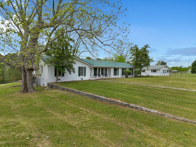single story home with a front lawn and fence