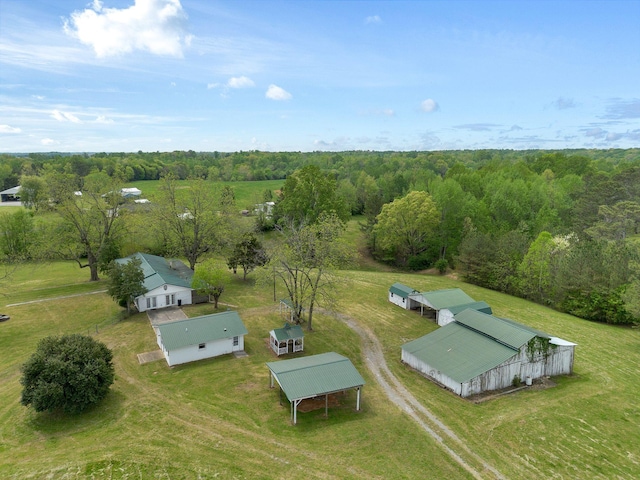 birds eye view of property with a view of trees