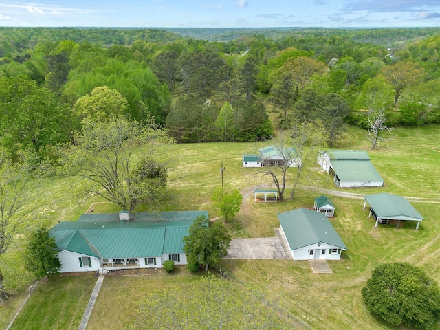 birds eye view of property with a view of trees