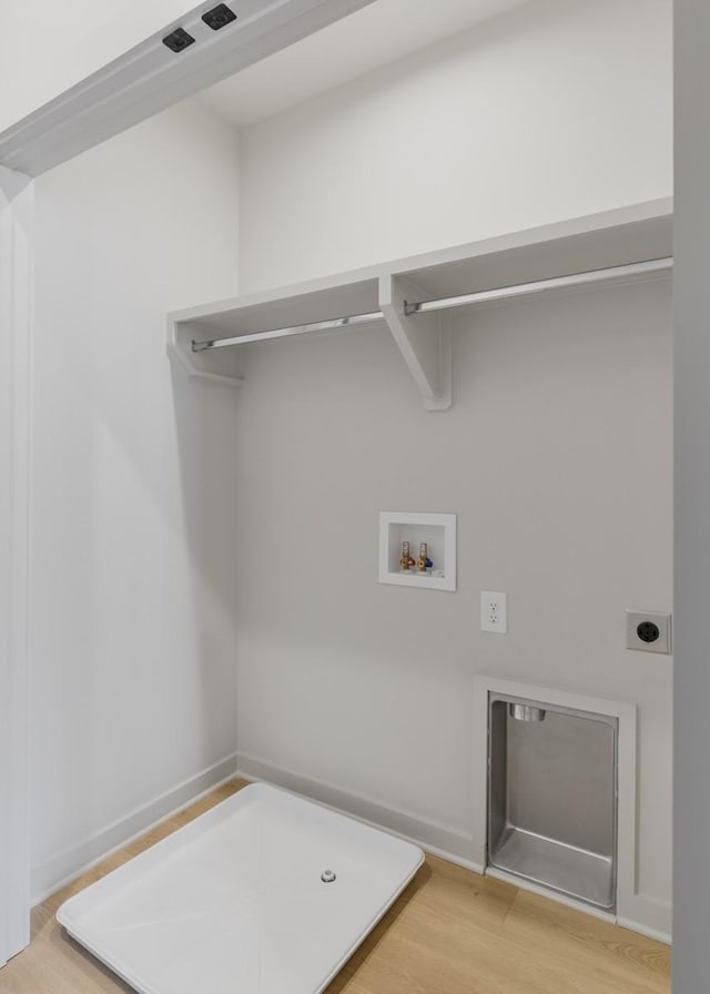 washroom with hookup for an electric dryer, light wood-style flooring, and washer hookup