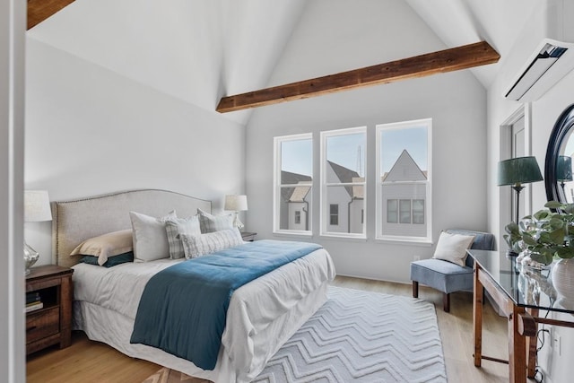 bedroom featuring a wall mounted AC, light wood-style flooring, beam ceiling, and high vaulted ceiling