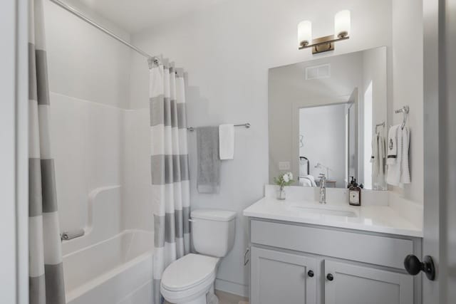 ensuite bathroom featuring visible vents, toilet, vanity, shower / bath combo with shower curtain, and ensuite bathroom