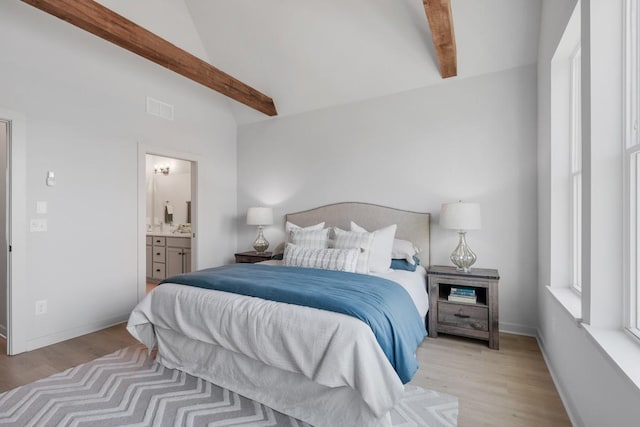 bedroom with visible vents, connected bathroom, beam ceiling, light wood-style flooring, and high vaulted ceiling