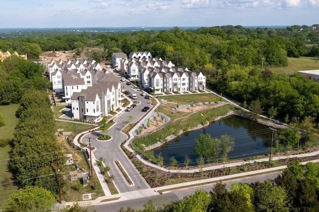 drone / aerial view featuring a view of trees and a water view