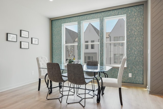 dining room with baseboards and wood finished floors