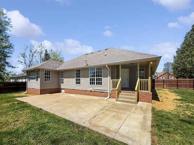 rear view of property with a lawn, crawl space, fence, and roof with shingles
