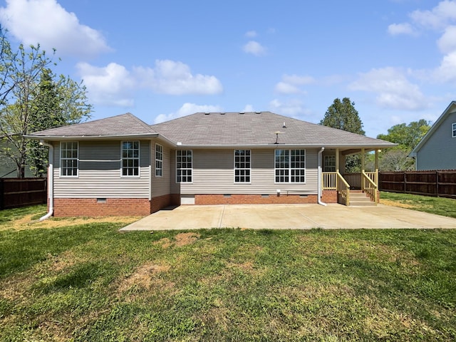 back of property featuring fence, crawl space, a shingled roof, and a patio area