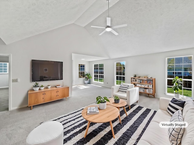 carpeted living area with baseboards, high vaulted ceiling, a textured ceiling, and ceiling fan
