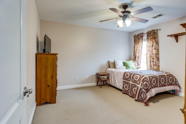 carpeted bedroom featuring baseboards, visible vents, and ceiling fan