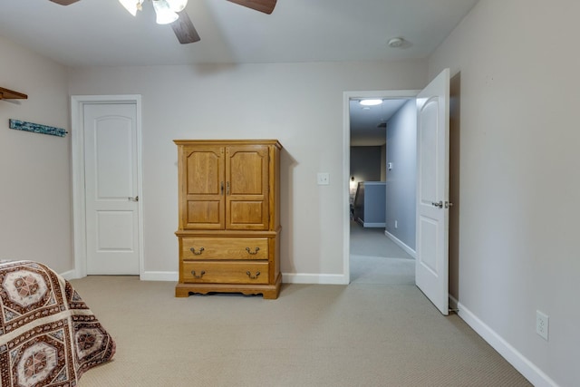 bedroom featuring a ceiling fan, baseboards, and light colored carpet