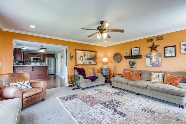 carpeted living area featuring recessed lighting, ceiling fan, and crown molding
