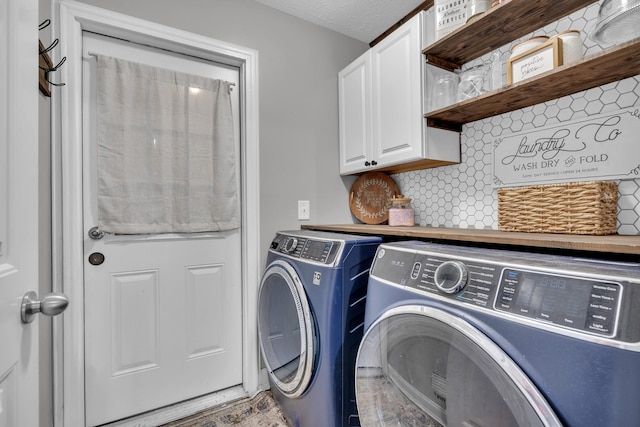 washroom featuring washer and dryer and cabinet space