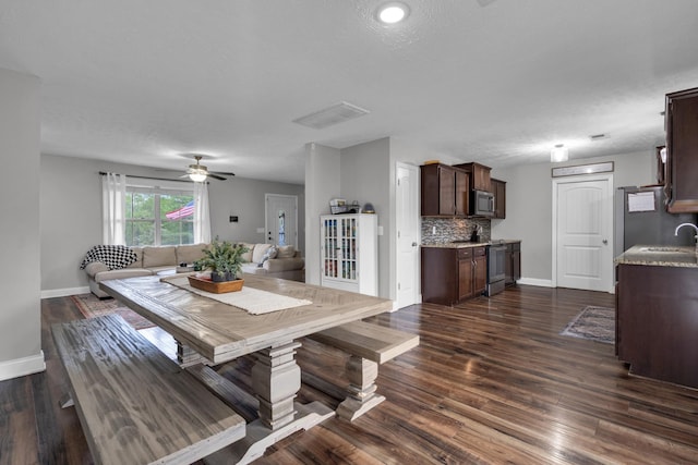 dining space with baseboards, ceiling fan, and dark wood-style floors