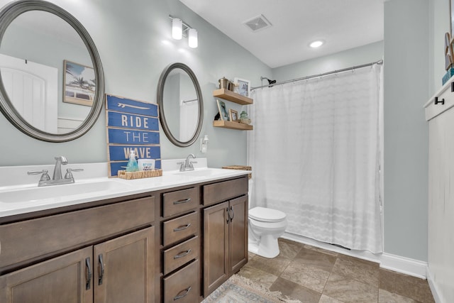 bathroom with double vanity, visible vents, toilet, and a sink
