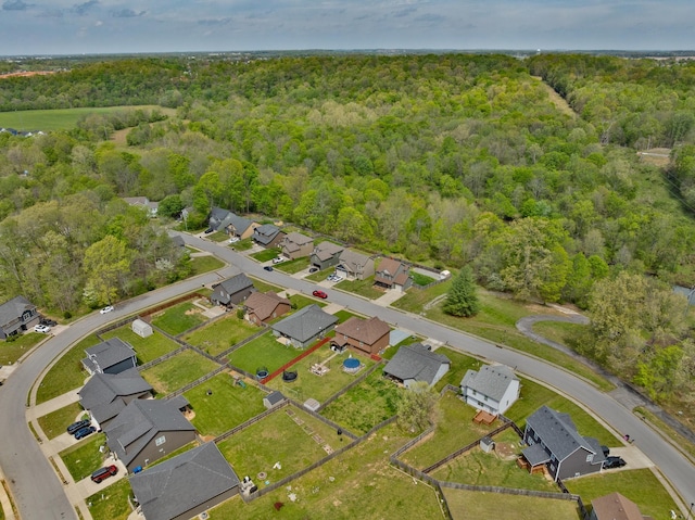 drone / aerial view with a residential view and a wooded view